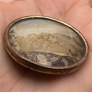  An 18th c. detailed painting under glass of traveler on bridge button.