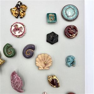 Card of thirty five ceramic buttons.