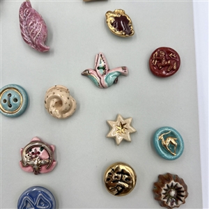 Card of thirty five ceramic buttons.