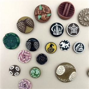 Card of thirty nine buffed celluloid buttons.