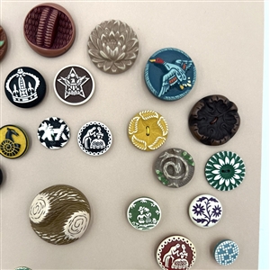 Card of thirty nine buffed celluloid buttons.