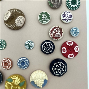 Card of thirty nine buffed celluloid buttons.