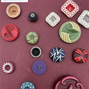Card of thirty four buffed celluloid buttons.