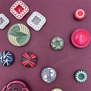 Card of thirty four buffed celluloid buttons.