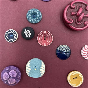 Card of thirty four buffed celluloid buttons.