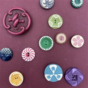 Card of thirty four buffed celluloid buttons.