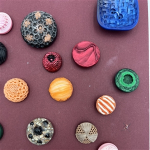 Card of thirty four French textured plastic buttons.