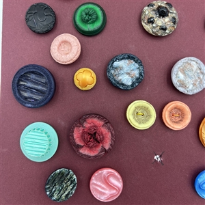 Card of thirty four French textured plastic buttons.