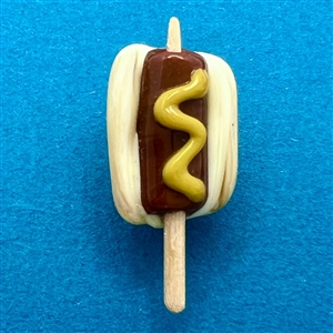 Mary Gaumond’s hot dog on a stick studio button.