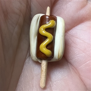 Mary Gaumond’s hot dog on a stick studio button.