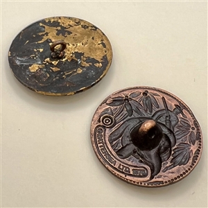 Two buttons of Teddy Roosevelt riding an elephant.
