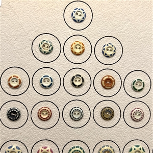 Card of 42 aluminum stencil buttons.