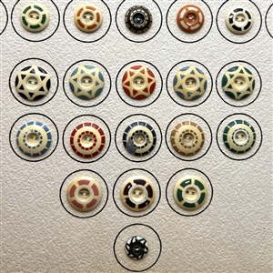 Card of 42 aluminum stencil buttons.