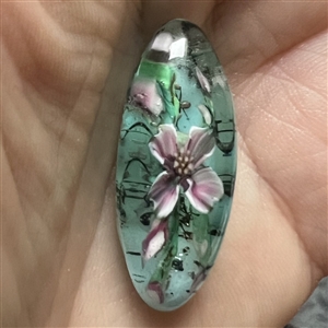 Mary Gaumond’s paper weight button of iris studio button.