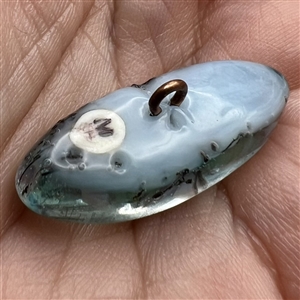 Mary Gaumond’s paper weight button of iris studio button.