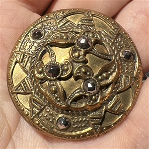 Victorian button of stamped brass with steels.