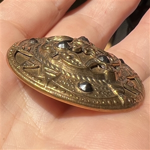 Victorian button of stamped brass with steels.