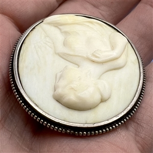 Cameo carved natural material set in silver button.