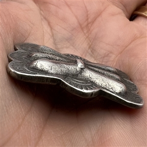 Pewter button with Native American butterfly design.