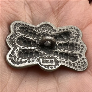 Pewter button with Native American butterfly design.