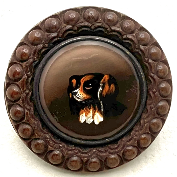 A 19th c. reverse-painted glass spaniel dog mounted in wood button. 