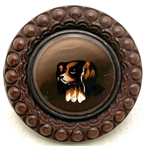A 19th c. reverse-painted glass spaniel dog mounted in wood button. 