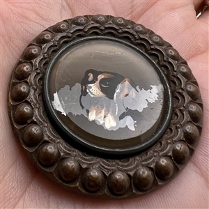 A 19th c. reverse-painted glass spaniel dog mounted in wood button. 