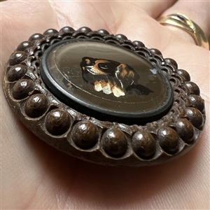 A 19th c. reverse-painted glass spaniel dog mounted in wood button. 