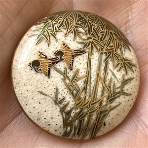 Satsuma button of two birds flying under bamboo.