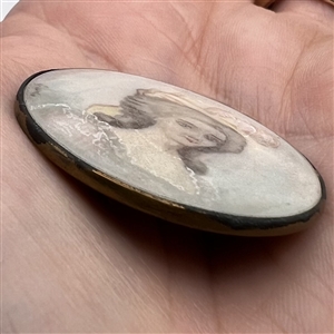 19th c. button painting in pastel tones of woman on natural material.