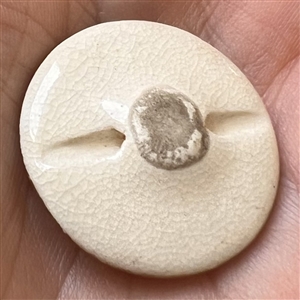 Satsuma button of two birds flying under bamboo.