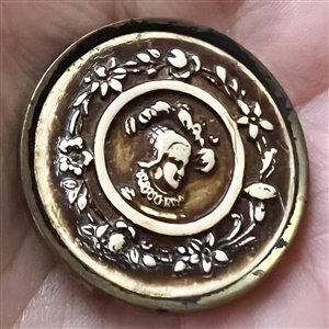 Ivoroid button of a man with floral inner border.