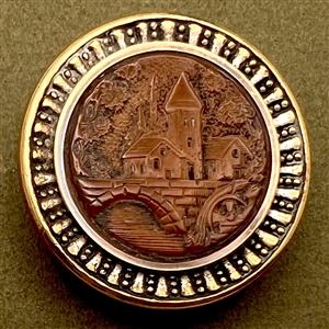 Vegetable ivory button of a bridge, waterwheel, and mill scene.