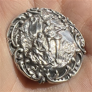 Hallmarked silver button of a courting couple.