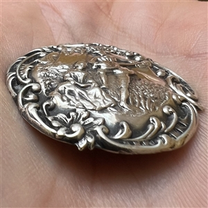 Hallmarked silver button of a courting couple.