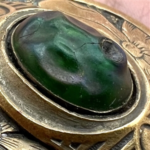 Gay 90’s type button with unique oval iridescent-green glass center.