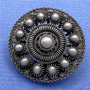Peasant silver filigree dress button.