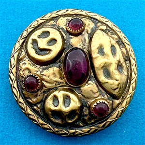 Arts and Crafts style brass button with amethyst glass.