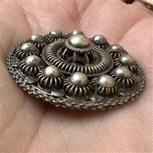 Peasant silver filigree dress button.