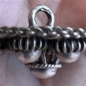 Peasant silver filigree dress button.