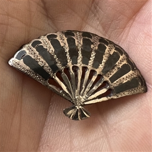 Niello silver button of a realistic fan.