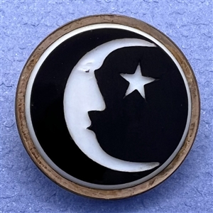 White & black glass “man in the moon” button. 