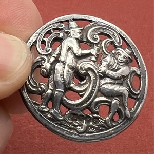 Hallmarked silver button of two men drinking.