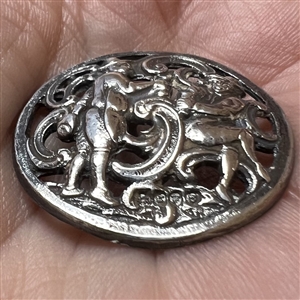 Hallmarked silver button of two men drinking.