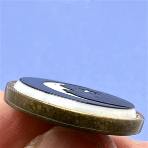White & black glass “man in the moon” button. 