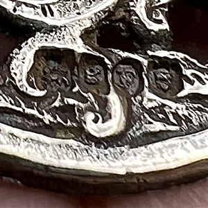 Hallmarked silver button of two men drinking.