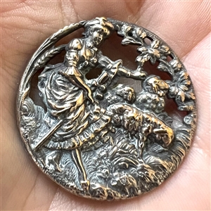 Silvered brass button of shepherdess and lambs.