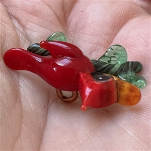 Mary Gaumond’s red bird glass studio button.