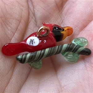 Mary Gaumond’s red bird glass studio button.