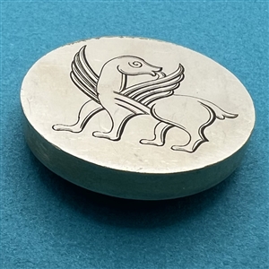Fabulous creature on metal button.